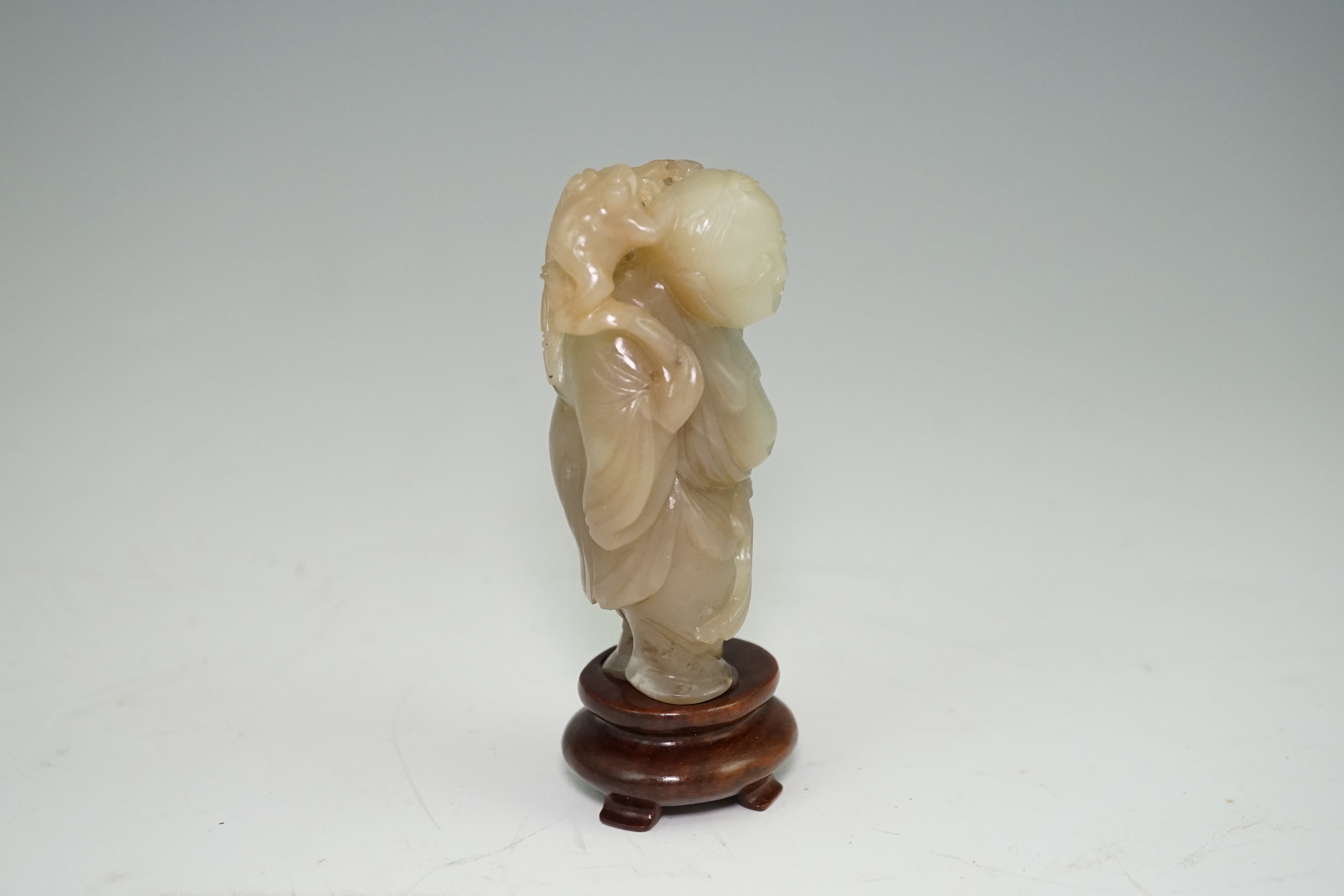 A Chinese pale celadon and brown jade group of Liu Hai and his three legged toad, Qianlong period (1736-95)